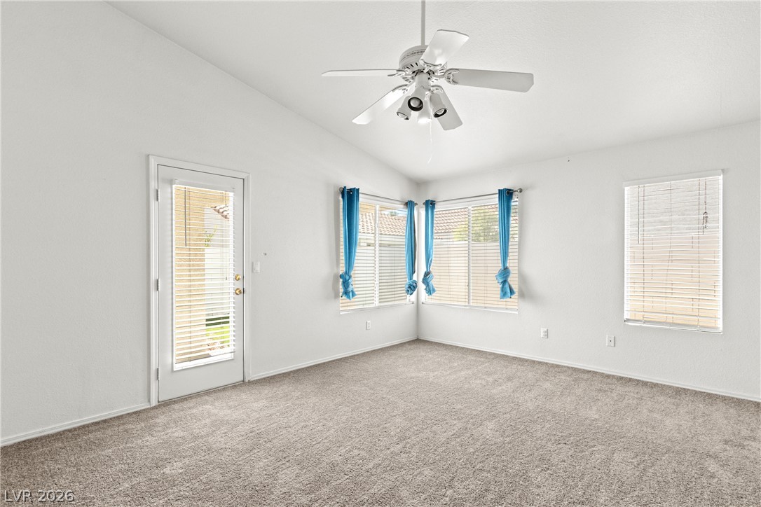 1815 Stablegate Avenue Henderson, NV 89012 - Photo 3 of 28 A quiet retreat with vaulted ceilings, featuring soft carpet flooring and abundant natural light.