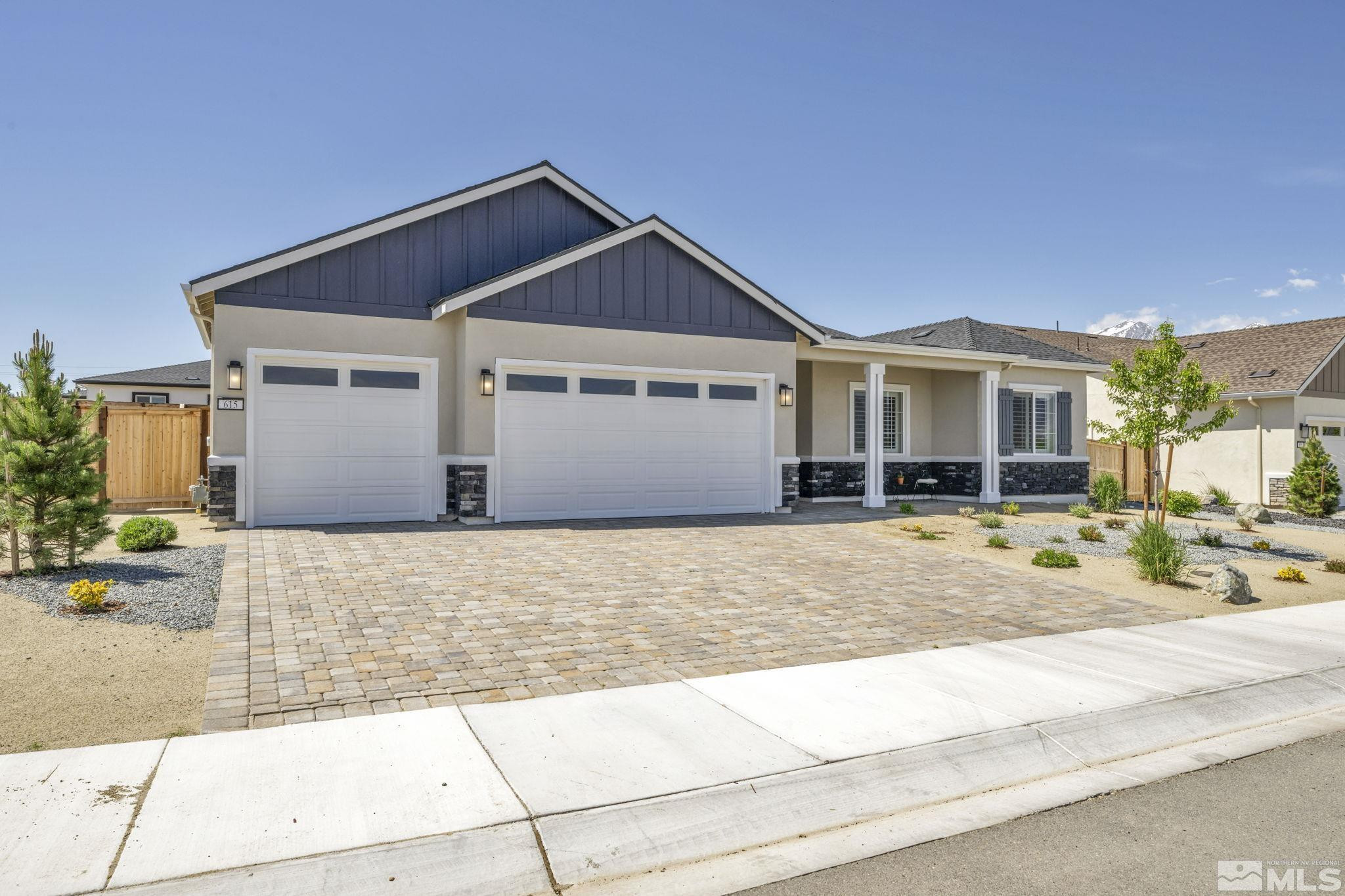 615 Sage Grouse Loop Stateline, NV 89449 - Photo 1 of 40 a front view of a house with a yard