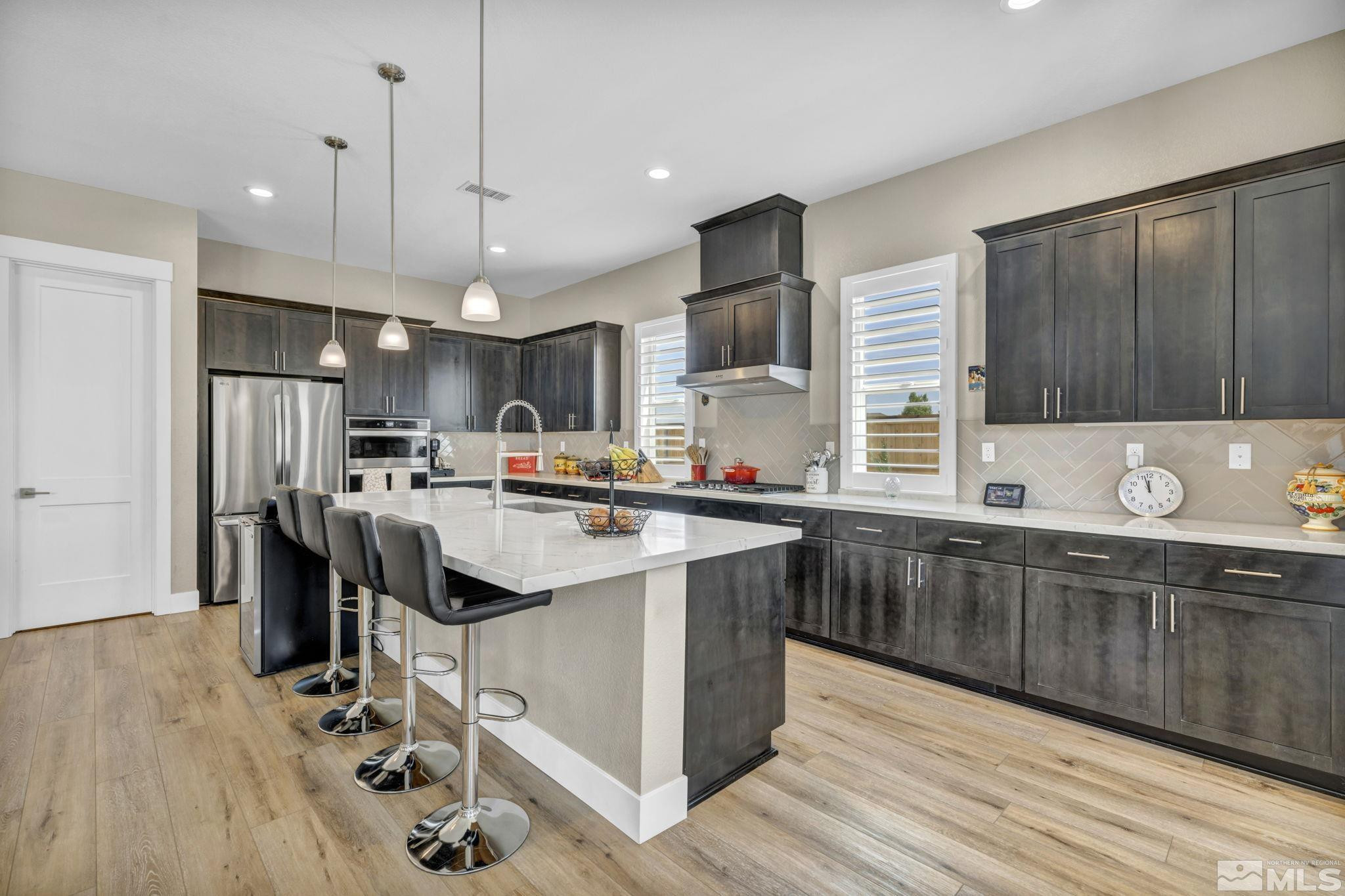615 Sage Grouse Loop Stateline, NV 89449 - Photo 11 of 40 a kitchen with kitchen island granite countertop a sink appliances and cabinets