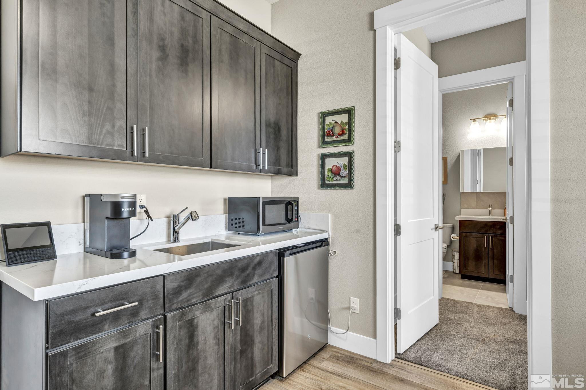 615 Sage Grouse Loop Stateline, NV 89449 - Photo 17 of 40 a kitchen with stainless steel appliances granite countertop a sink stove and refrigerator