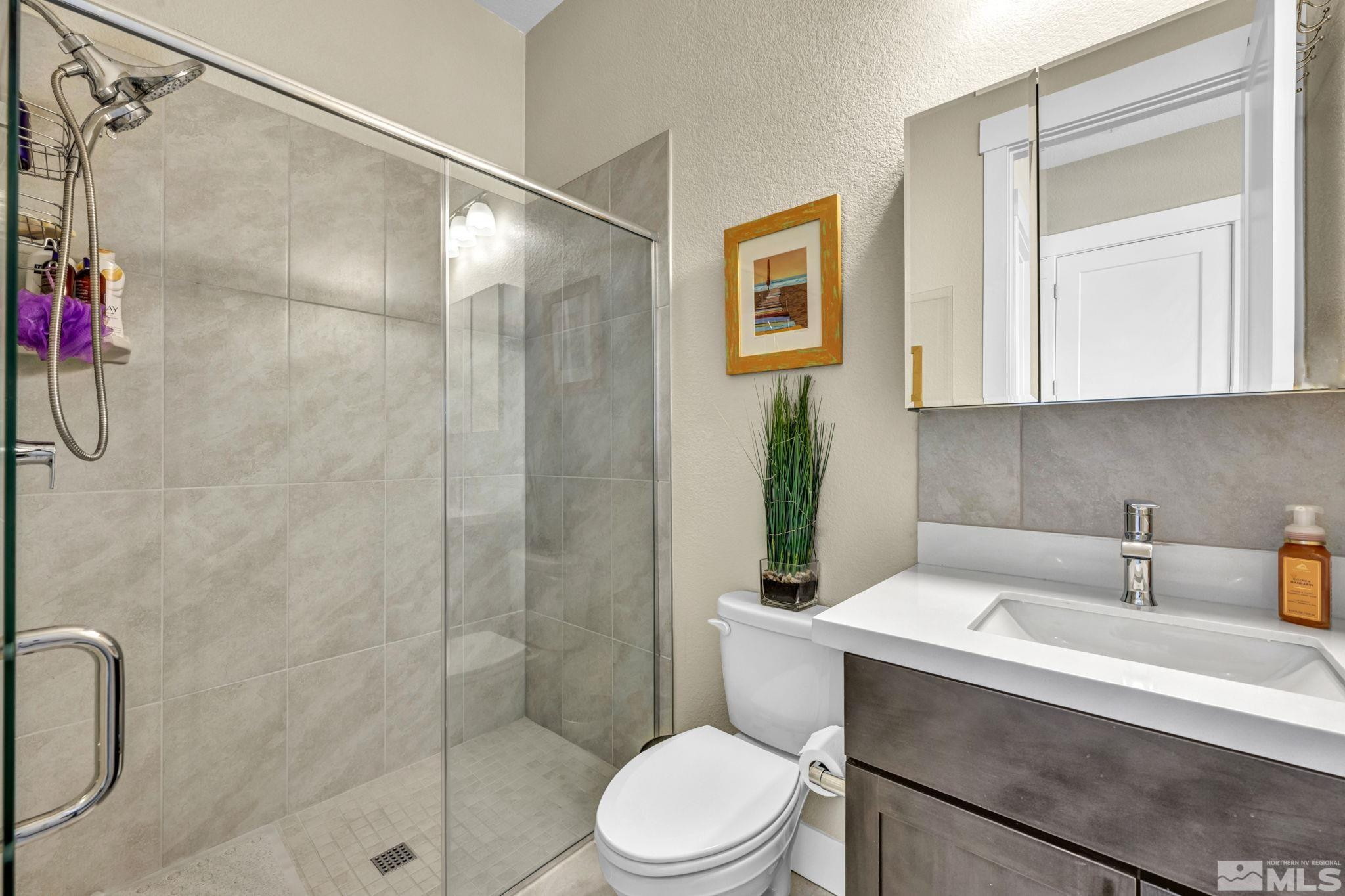 615 Sage Grouse Loop Stateline, NV 89449 - Photo 18 of 40 a bathroom with a sink toilet and shower