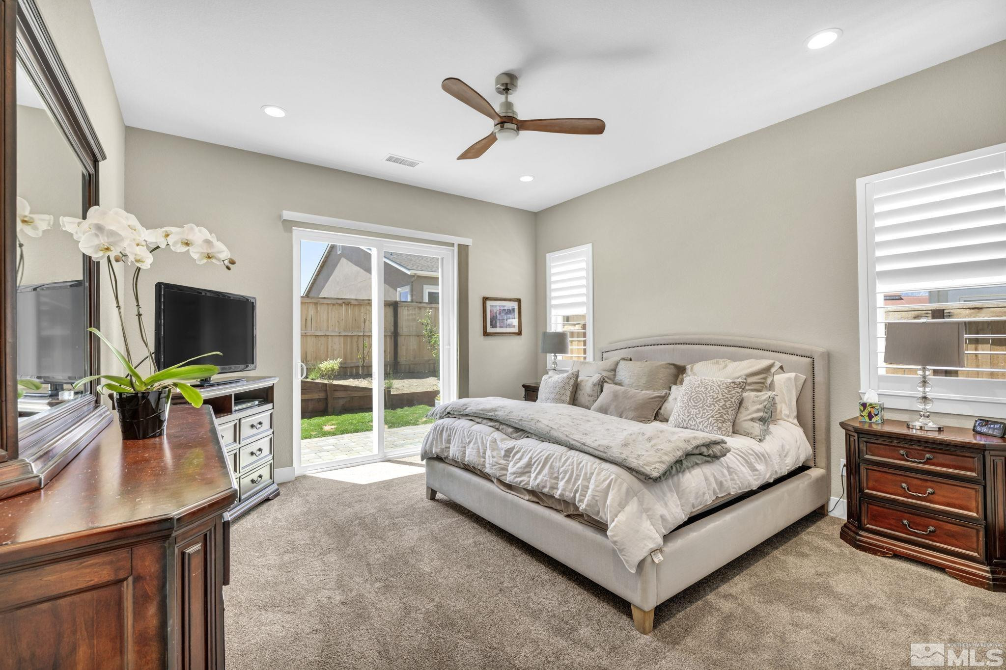 615 Sage Grouse Loop Stateline, NV 89449 - Photo 20 of 40 a spacious bedroom with a bed a flat screen tv and a dresser