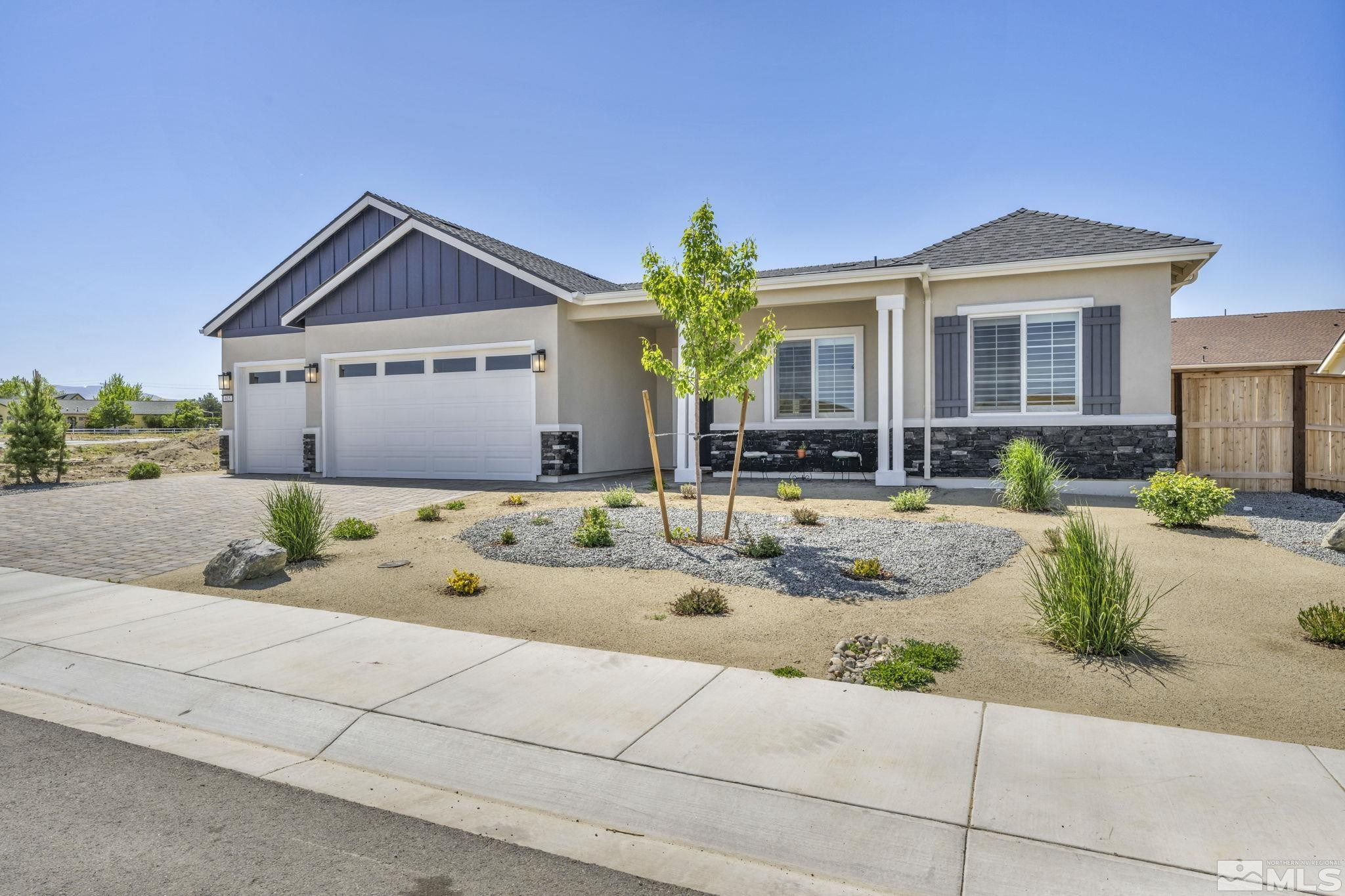 615 Sage Grouse Loop Stateline, NV 89449 - Photo 2 of 40 a front view of a house with a yard and potted plants