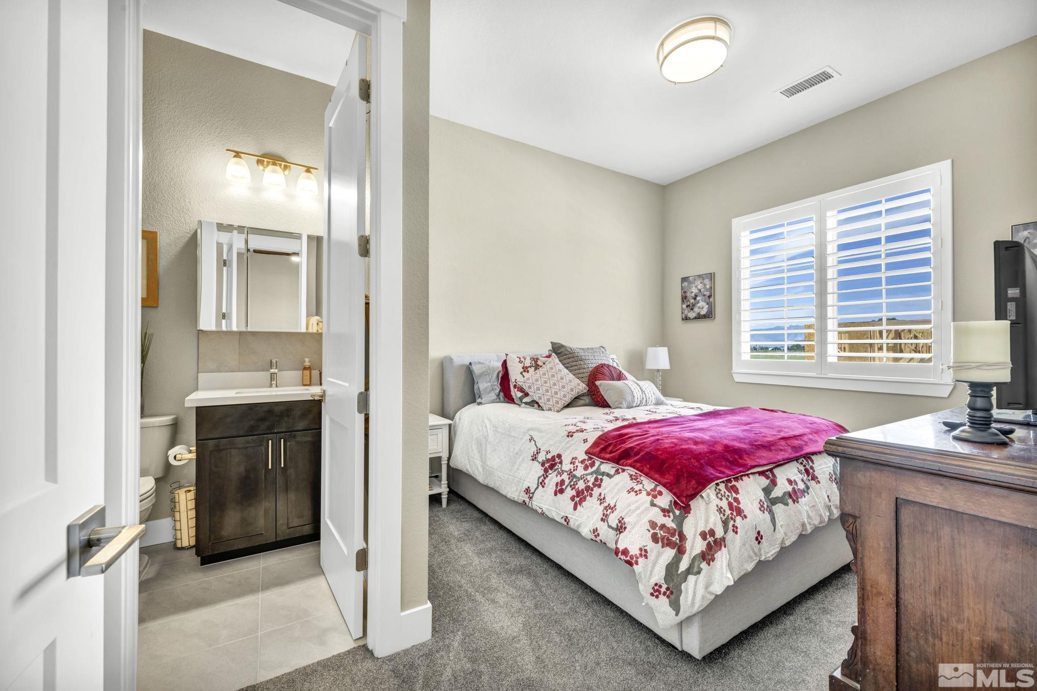 615 Sage Grouse Loop Stateline, NV 89449 - Photo 27 of 40 a bedroom with a bed and a fireplace