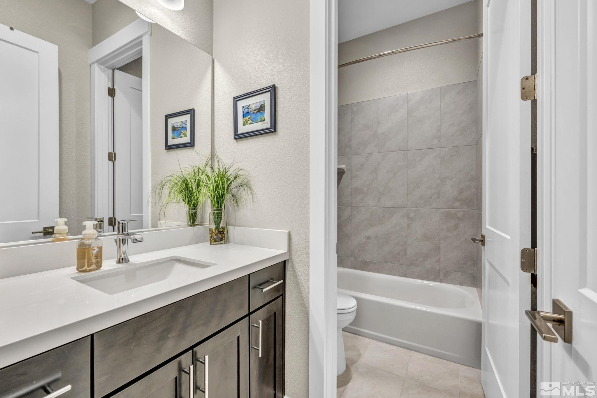 615 Sage Grouse Loop Stateline, NV 89449 - Photo 28 of 40 a bathroom with a sink a bathtub and a mirror