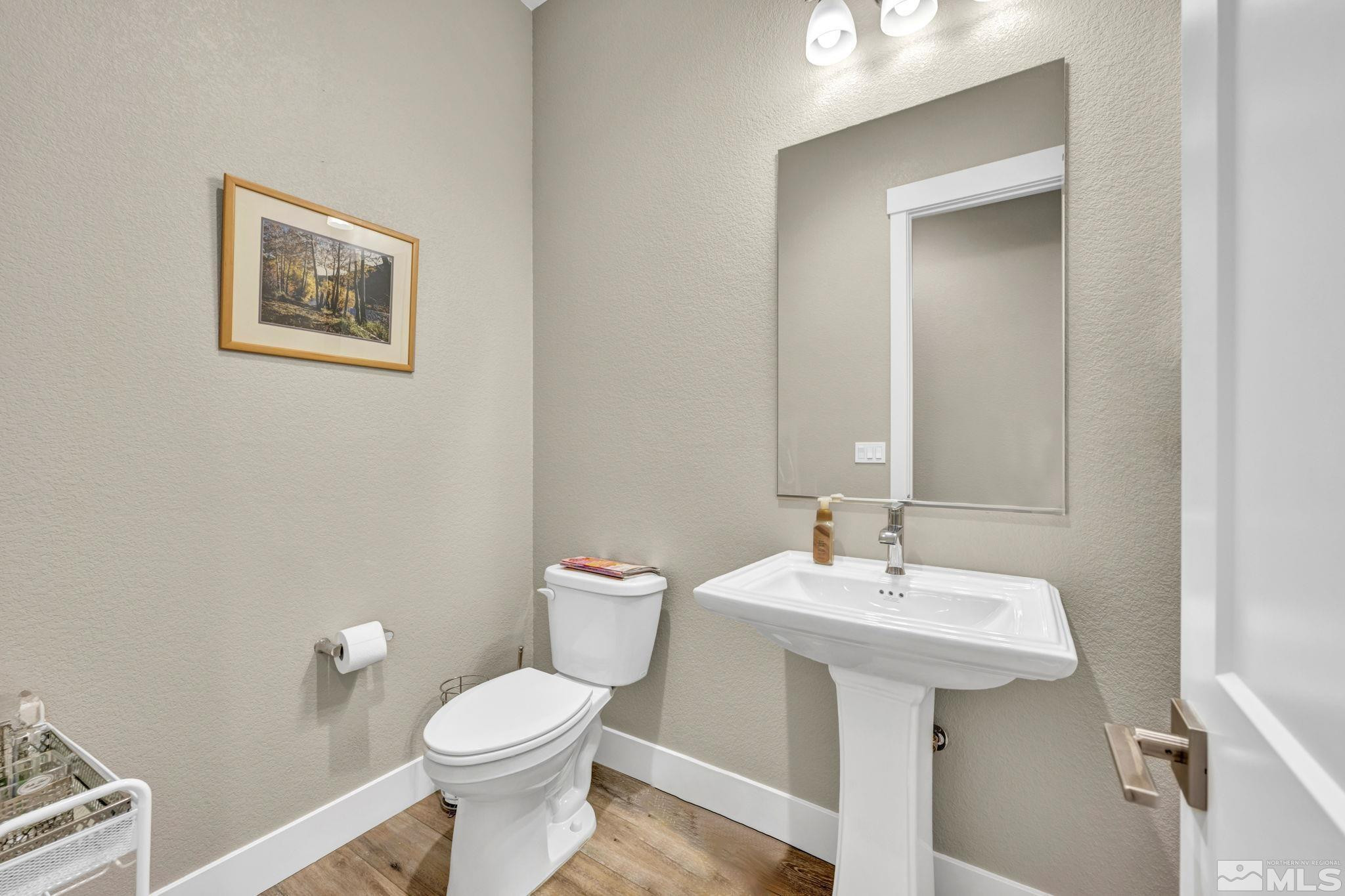 615 Sage Grouse Loop Stateline, NV 89449 - Photo 31 of 40 a bathroom with a toilet sink and mirror