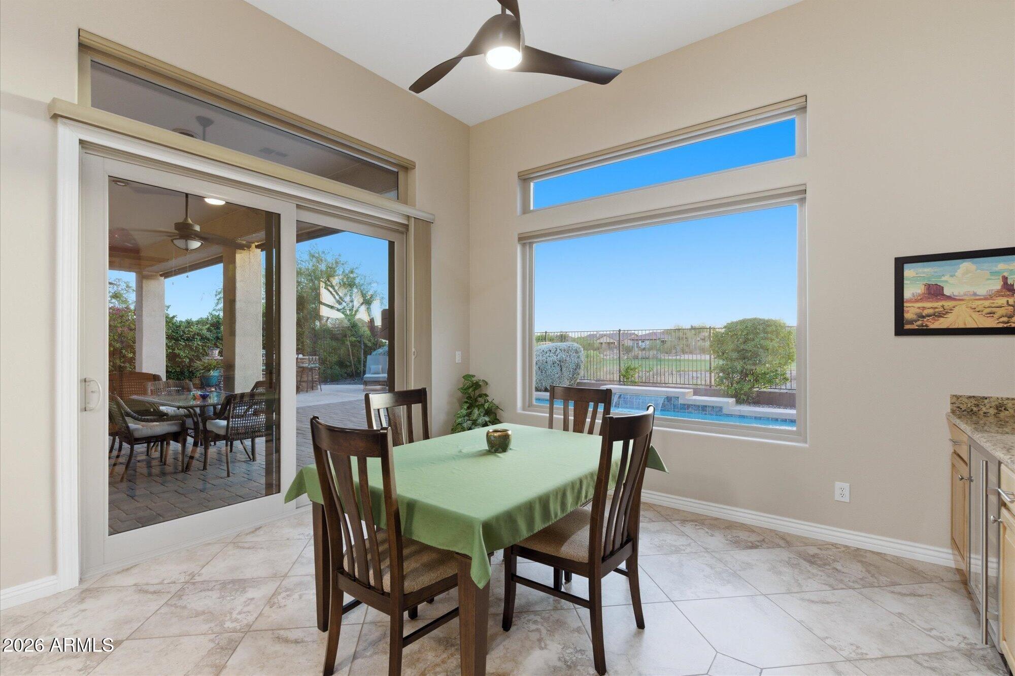40322 North Hawk Ridge Trail Anthem, AZ 85086 - Photo 15 of 63 a dining room with furniture and a floor to ceiling window