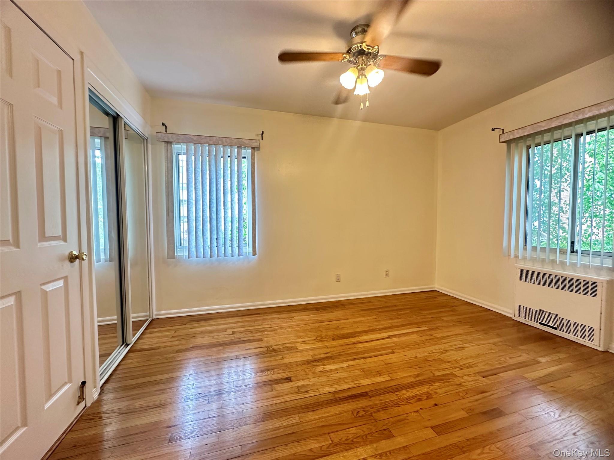 129 Fenimore Road, Unit 129B Mamaroneck, NY 10543 - Photo 6 of 19 Bedroom 1 with dual closets, ceiling fan, in-wall AC unit