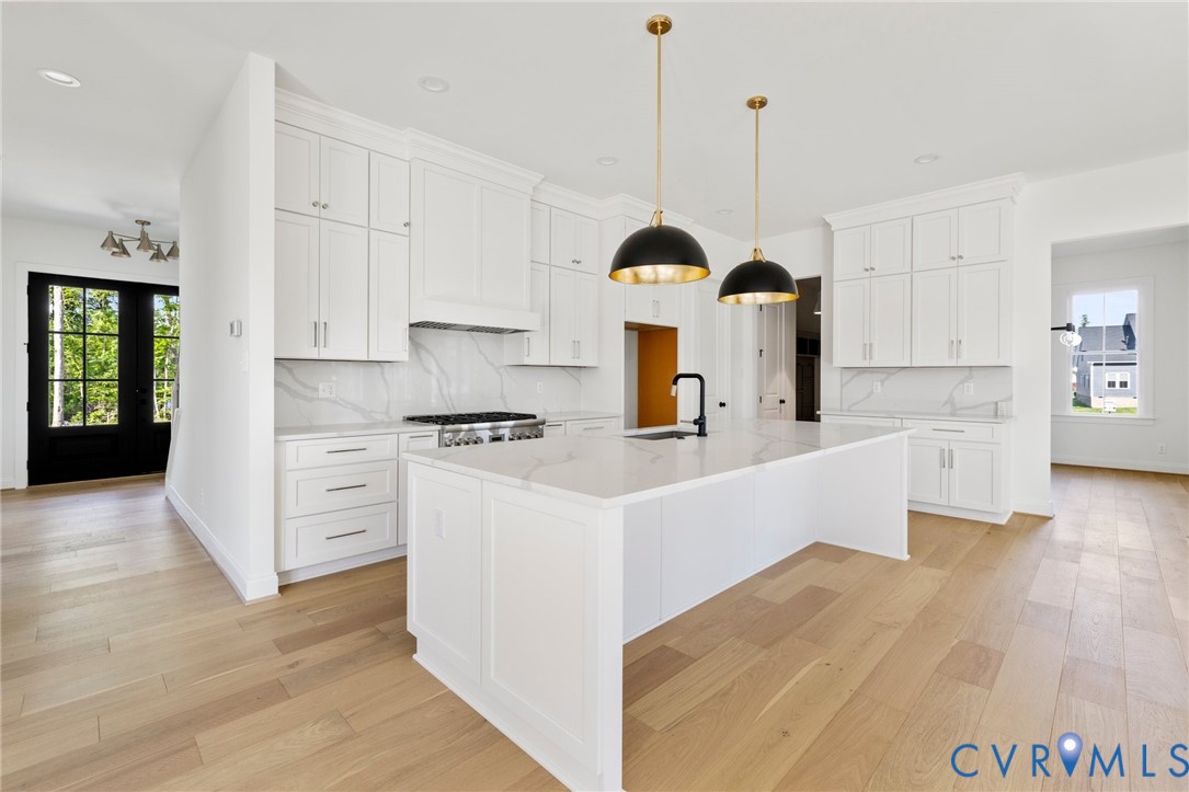 4624 Lake Summer Loop Moseley, VA 23120 - Photo 11 of 36 a kitchen with kitchen island a sink a stove and cabinets