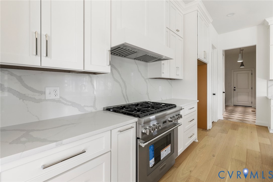 4624 Lake Summer Loop Moseley, VA 23120 - Photo 12 of 36 a kitchen with granite countertop a stove and a sink