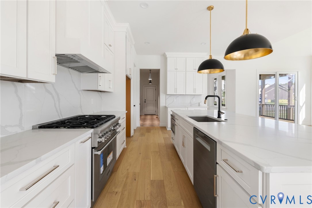 4624 Lake Summer Loop Moseley, VA 23120 - Photo 13 of 36 a kitchen with stainless steel appliances granite countertop a sink a stove and a wooden floors