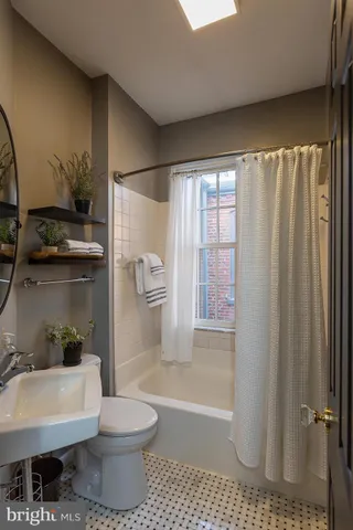 a view of a livingroom with workspace and a window