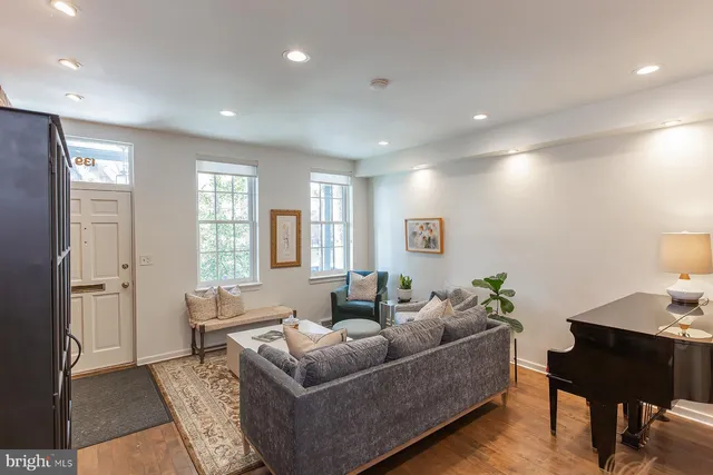 a living room with furniture and wooden floor