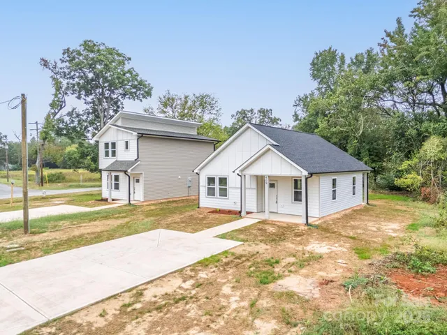 a front view of a house with trees