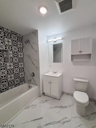 a bathroom with a toilet sink and bathtub