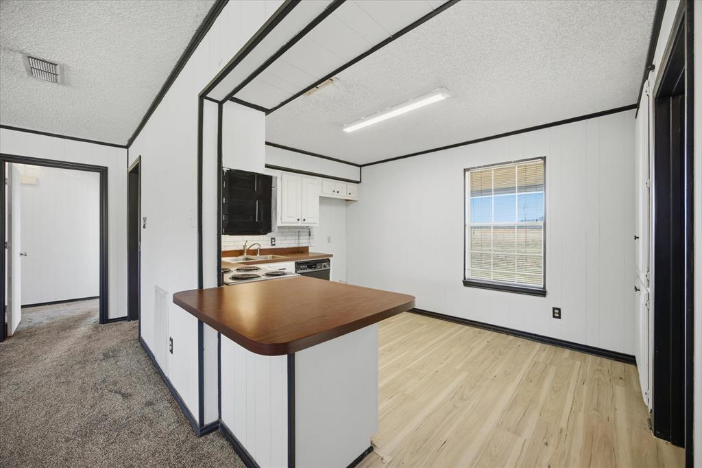 13409 County Road 349 Terrell, TX 75161 - Photo 19 of 27 a view of a kitchen with a sink and dishwasher with wooden floor