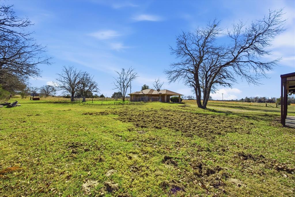 13409 County Road 349 Terrell, TX 75161 - Photo 2 of 27 a large building with trees in the background