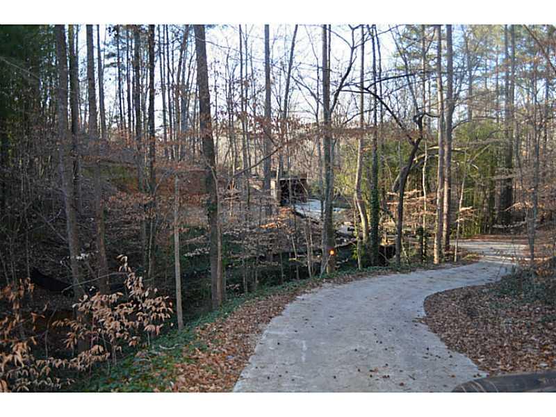 3966 North Berkeley Lake Road Northwest Berkeley Lake, GA 30096 - Photo 1 of 1 Exterior Front. Halfway up driveway-lot is on other side of creek/stream that runs from Berkeley Lake to the Chattahoochee-Lake refilling now-noisy shoals coming!
