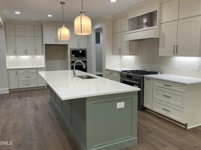 a kitchen with a stove a sink and a refrigerator