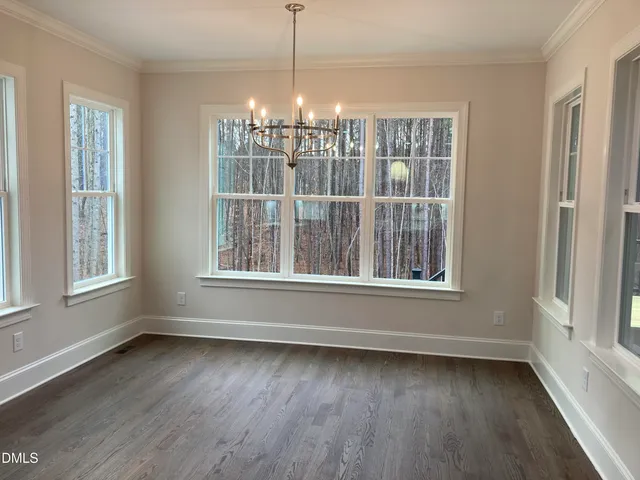 a view of a room with wooden floor and windows