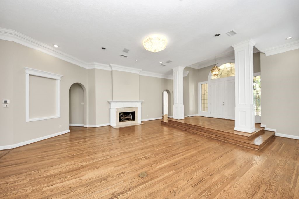 169 Grogans Point Road The Woodlands, TX 77380 - Photo 11 of 46 The gas fireplace with custom, French wrought iron grate helps makes this space cozy and warm.
