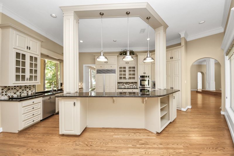 169 Grogans Point Road The Woodlands, TX 77380 - Photo 12 of 46 The modern, commercial style tier lighting adds a "cool" edge to this raised breakfast bar.