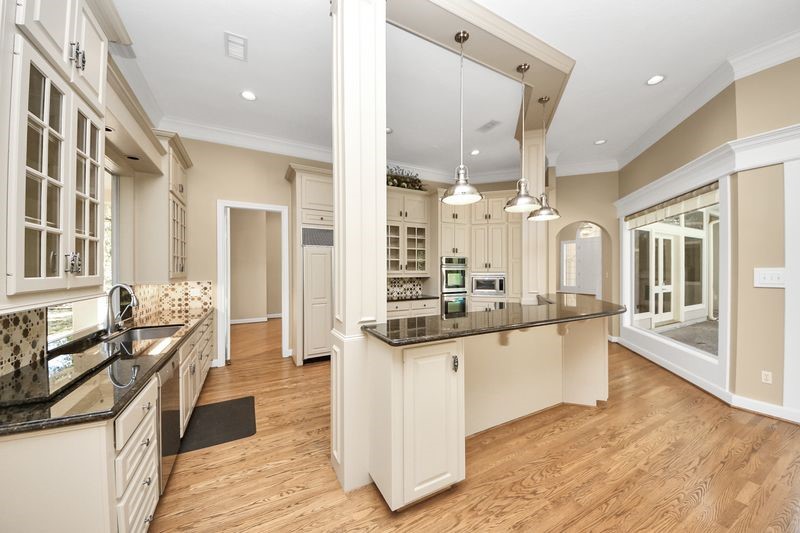 169 Grogans Point Road The Woodlands, TX 77380 - Photo 17 of 46 The kitchen boasts high end stainless appliances, glass front cabinetry, unique hardware and a "one of a kind" custom backsplash!