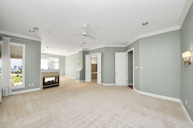 a view of an empty room with window and fire place