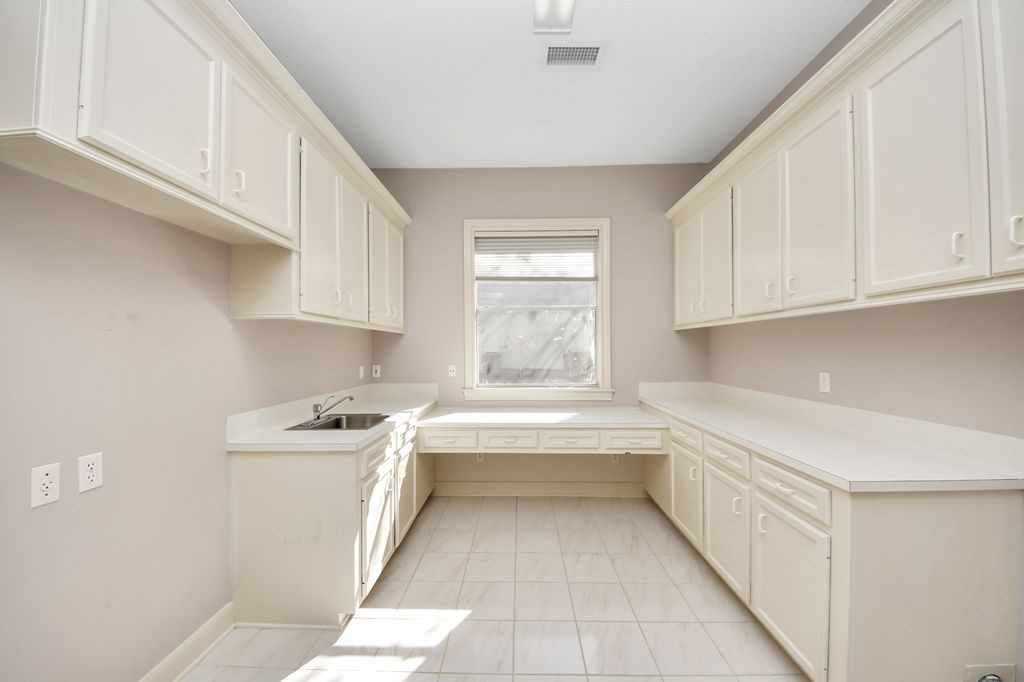 169 Grogans Point Road The Woodlands, TX 77380 - Photo 36 of 46 The utility room is huge! There is room for a full-size refrigerator. It also has desk space, a folding area & direct access to the primary closet.