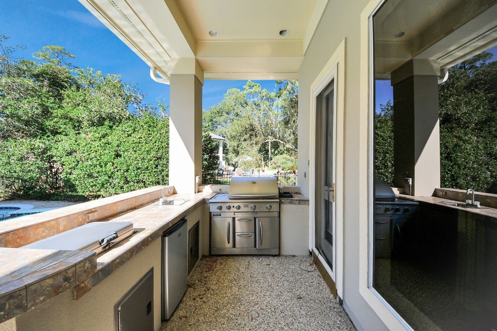 169 Grogans Point Road The Woodlands, TX 77380 - Photo 37 of 46 The outdoor kitchen has easy access to the kitchen & family room, while overlooking the pool.