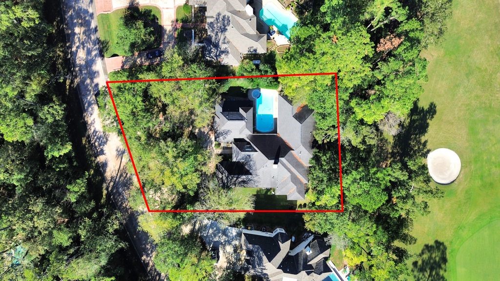 169 Grogans Point Road The Woodlands, TX 77380 - Photo 6 of 46 This home has a wonderfully unique layout, the pool is in the courtyard for extra privacy, and the back yard has tranquil views of the golf course. Notice the architectural, 30-year composition roof!