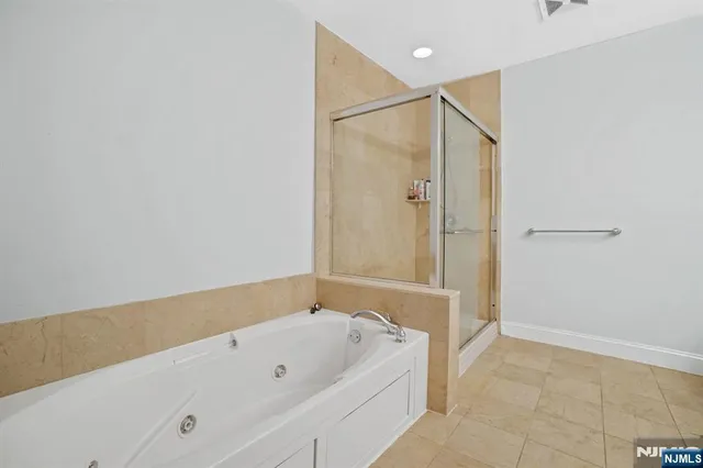 a spacious bathroom with a double vanity sink a toilet and a mirror