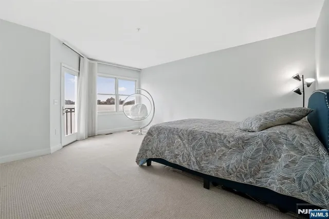 a bedroom with a bed and glass window