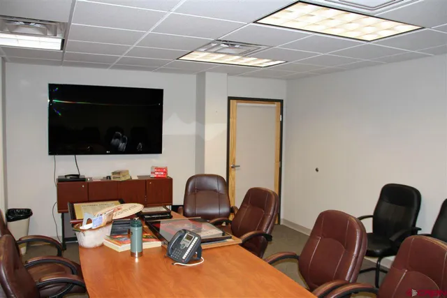 a workspace with furniture and flat screen tv