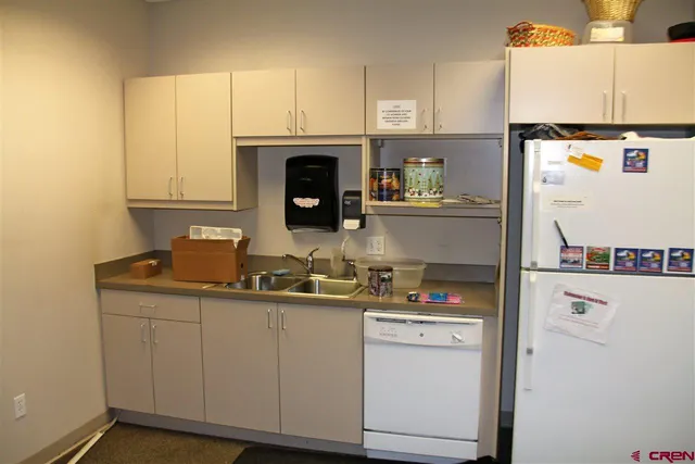 a kitchen with a sink a stove and cabinets