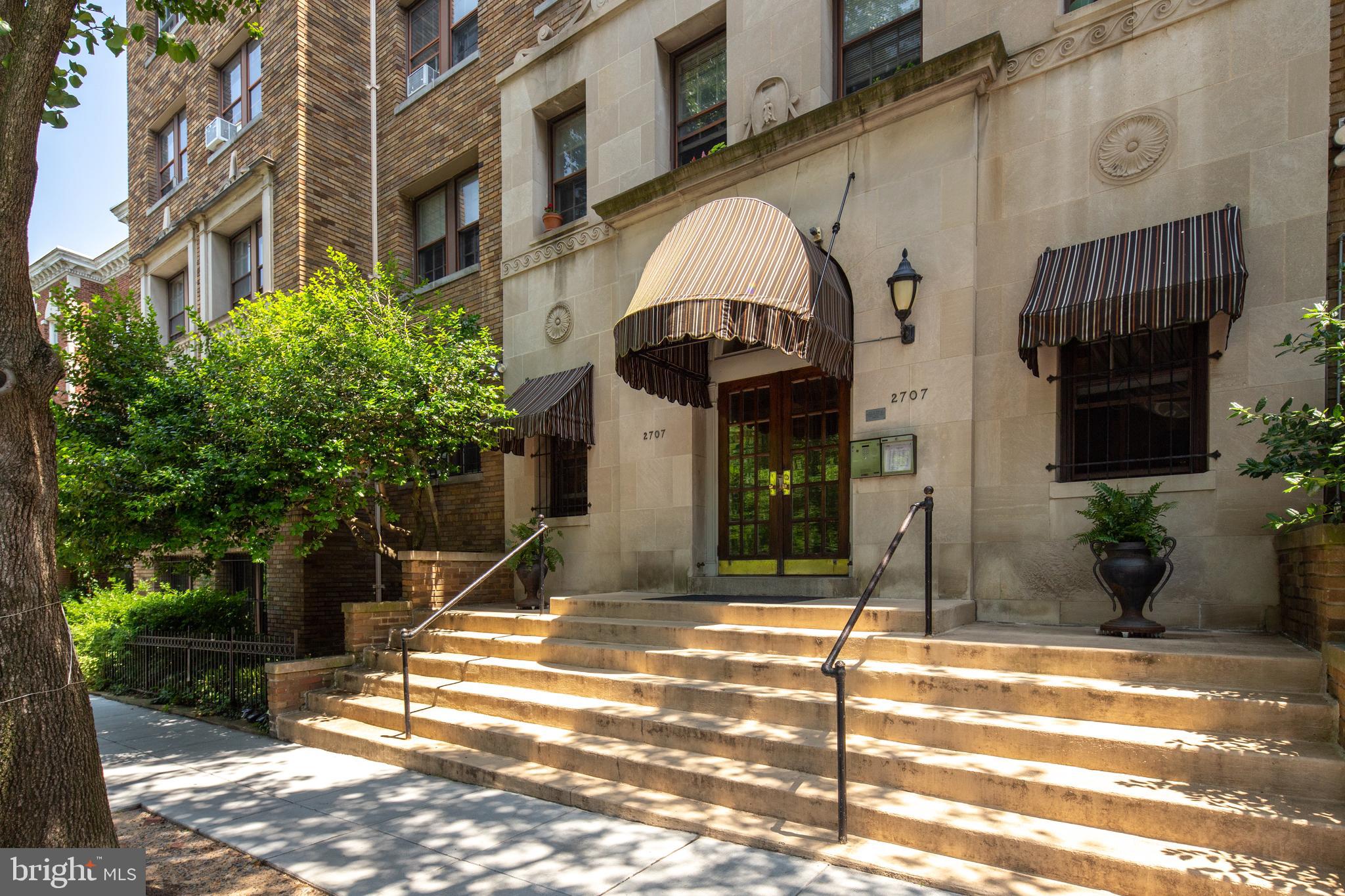 a view of a brick building with many windows