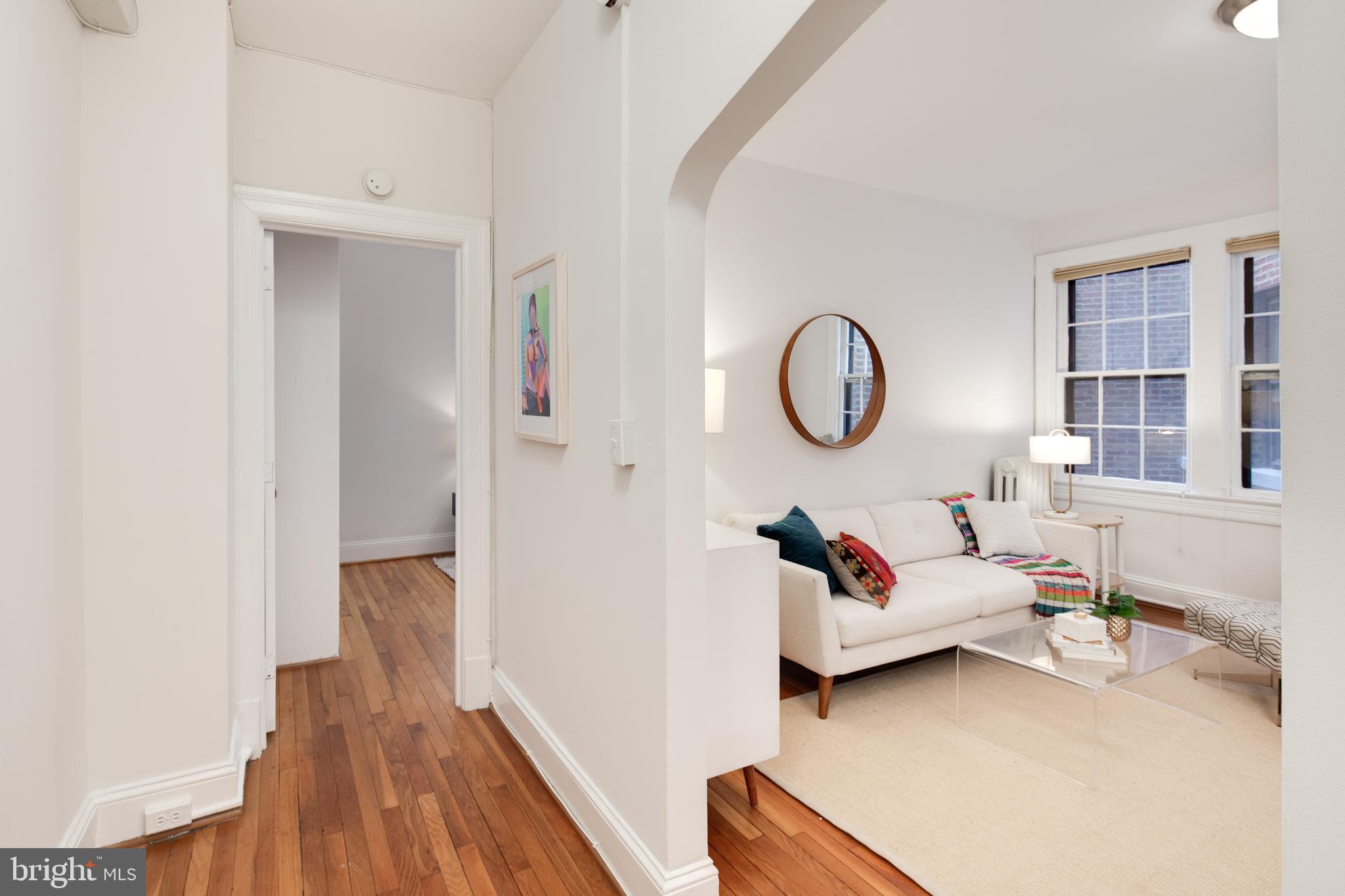 2707 Adams Mill Road Northwest, Unit 303 Washington, DC 20009 - Photo 18 of 30 a living room with furniture and a wooden floor