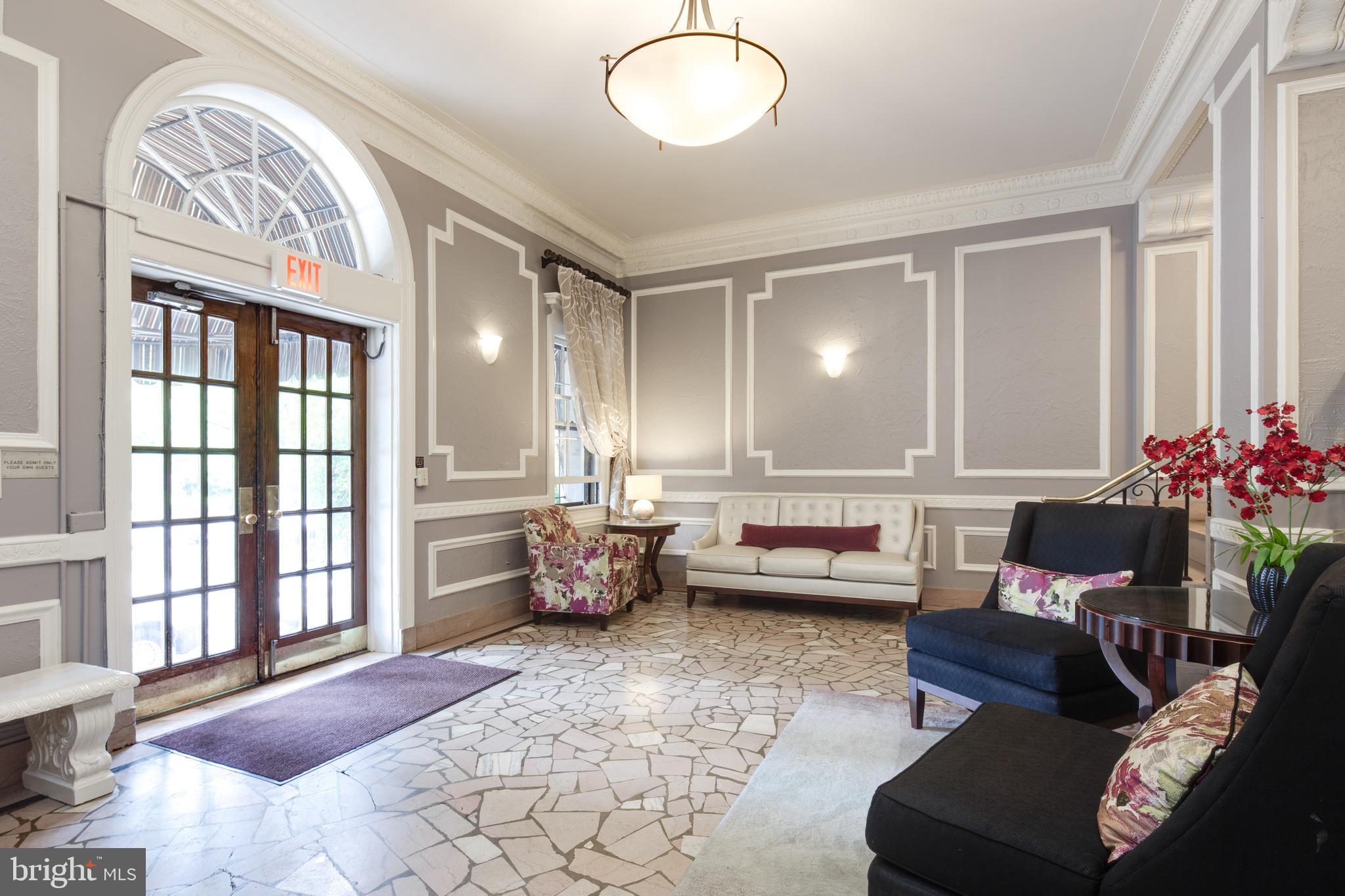 2707 Adams Mill Road Northwest, Unit 303 Washington, DC 20009 - Photo 3 of 30 a living room with furniture and a large window