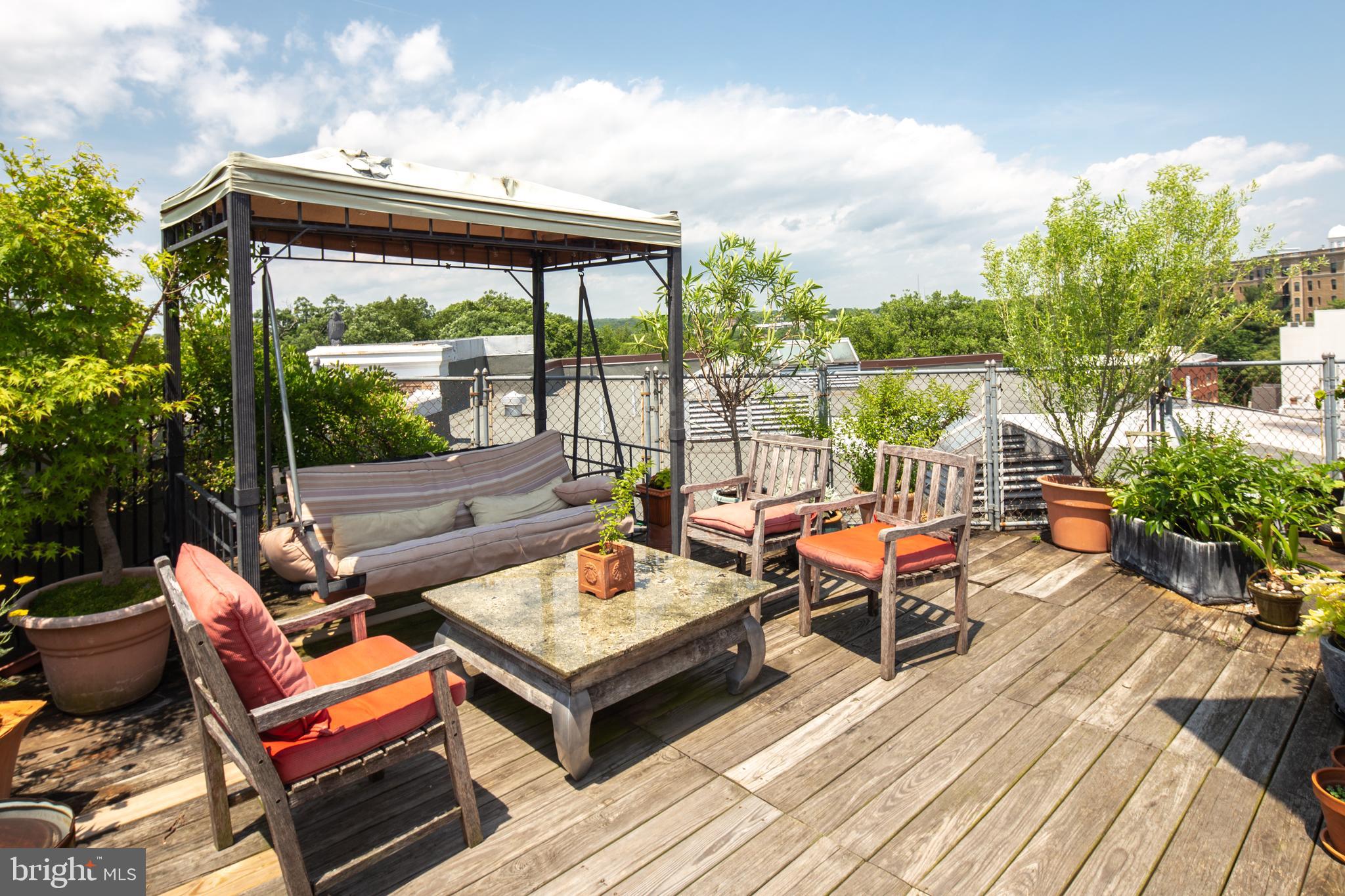 2707 Adams Mill Road Northwest, Unit 303 Washington, DC 20009 - Photo 26 of 30 a view of a patio with a dining table and chairs with wooden floor