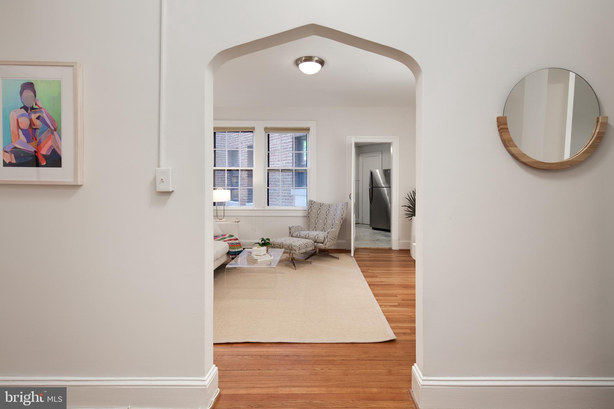 2707 Adams Mill Road Northwest, Unit 303 Washington, DC 20009 - Photo 4 of 30 an entryway and a livingroom with furniture