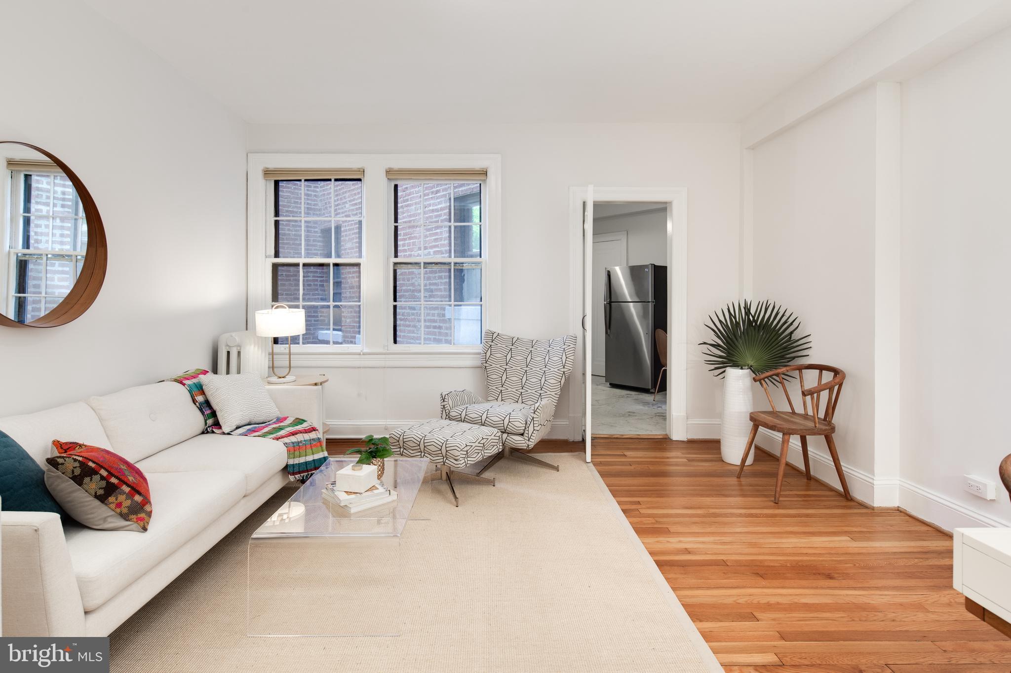 2707 Adams Mill Road Northwest, Unit 303 Washington, DC 20009 - Photo 5 of 30 a living room with furniture and a window