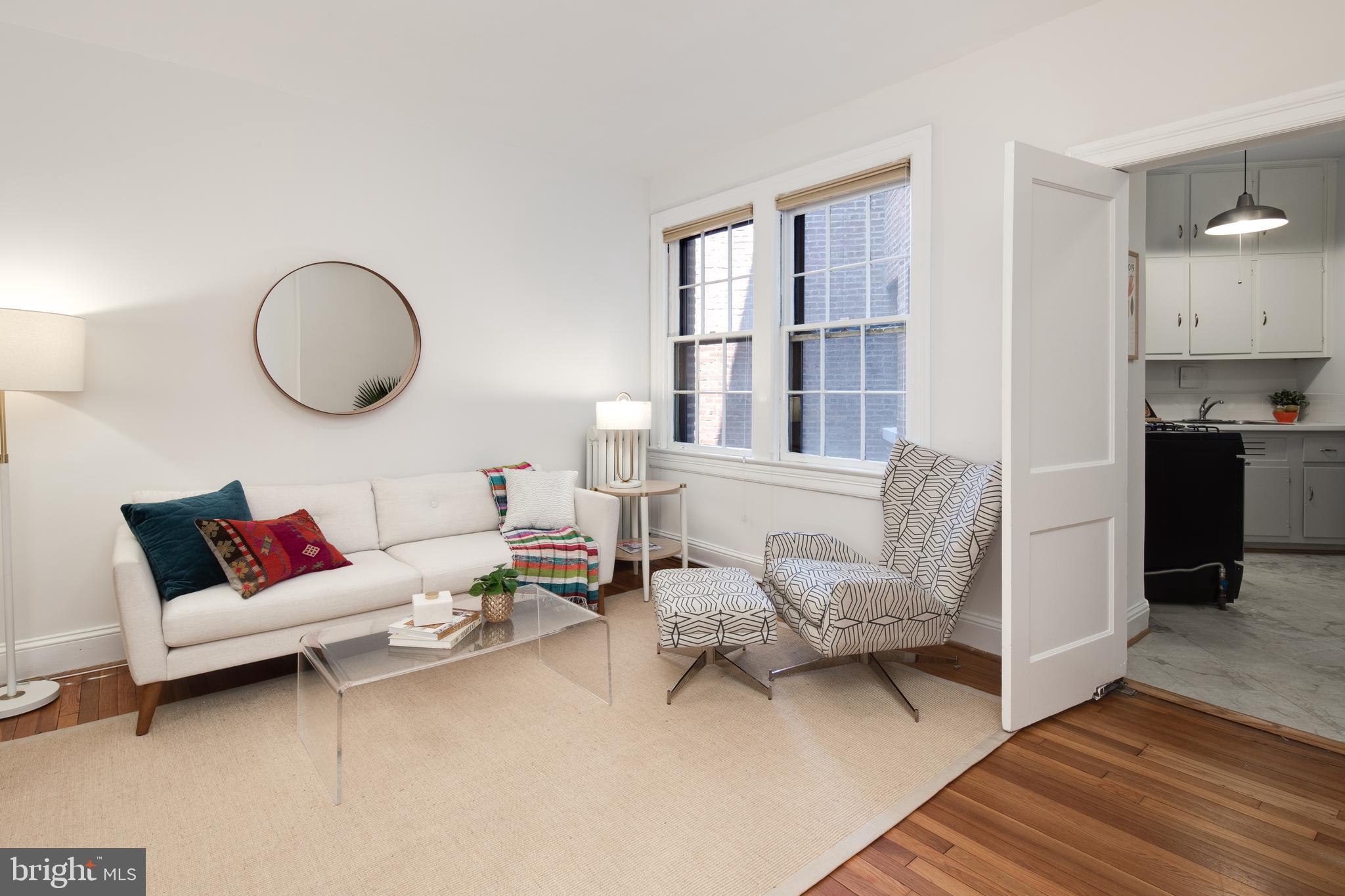 2707 Adams Mill Road Northwest, Unit 303 Washington, DC 20009 - Photo 6 of 30 a living room with furniture and a wooden floor