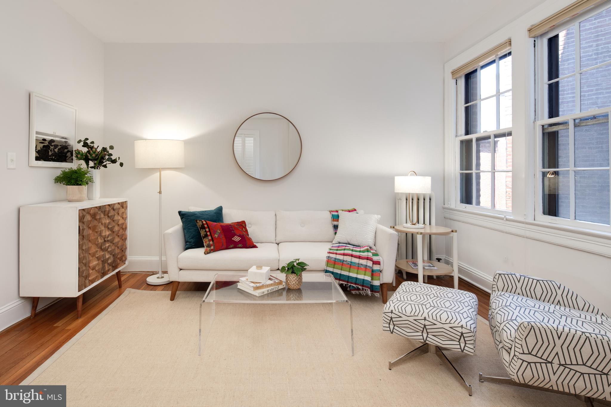 2707 Adams Mill Road Northwest, Unit 303 Washington, DC 20009 - Photo 7 of 30 a living room with furniture and a window