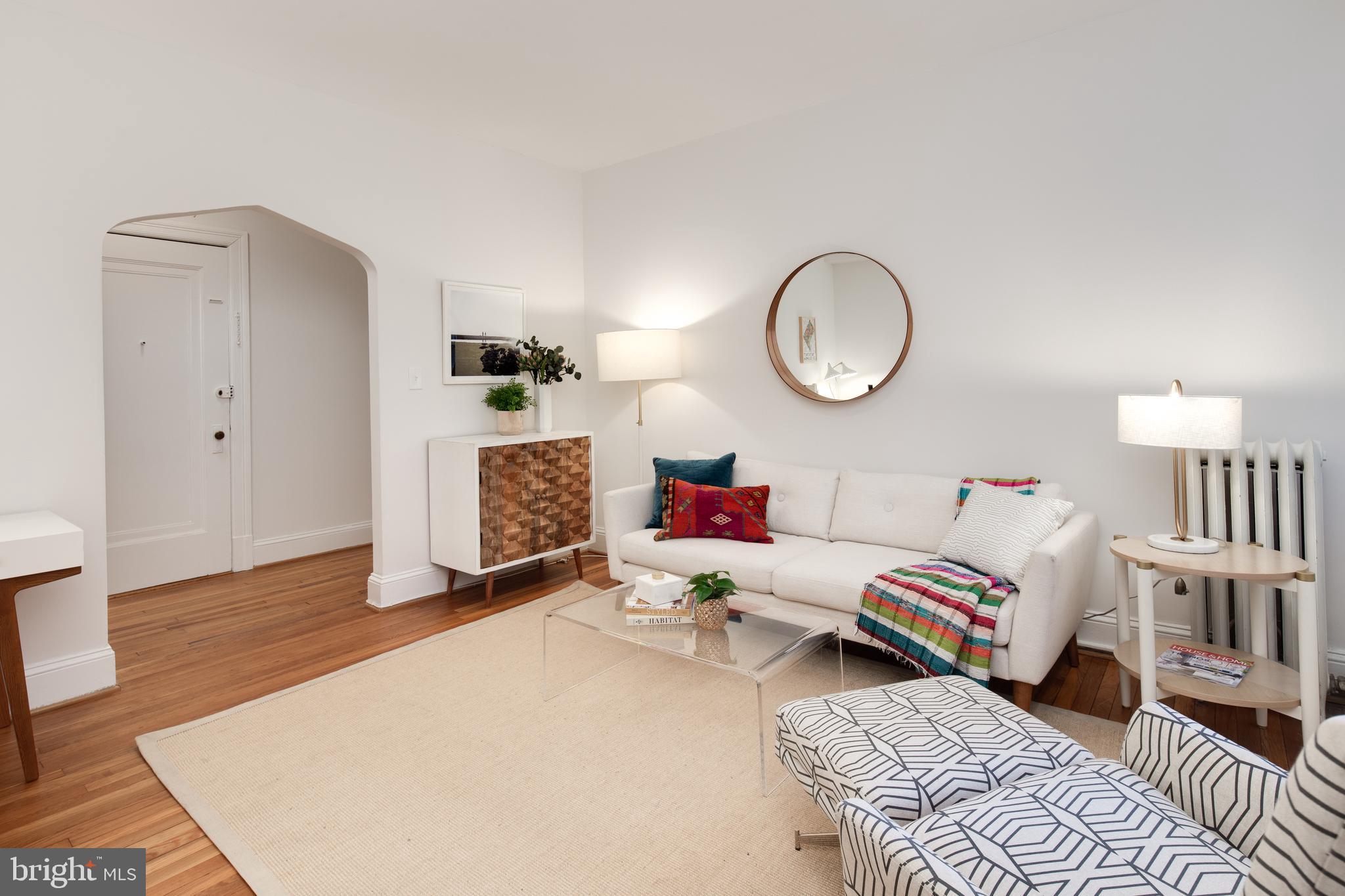2707 Adams Mill Road Northwest, Unit 303 Washington, DC 20009 - Photo 8 of 30 a living room with furniture and a wooden floor