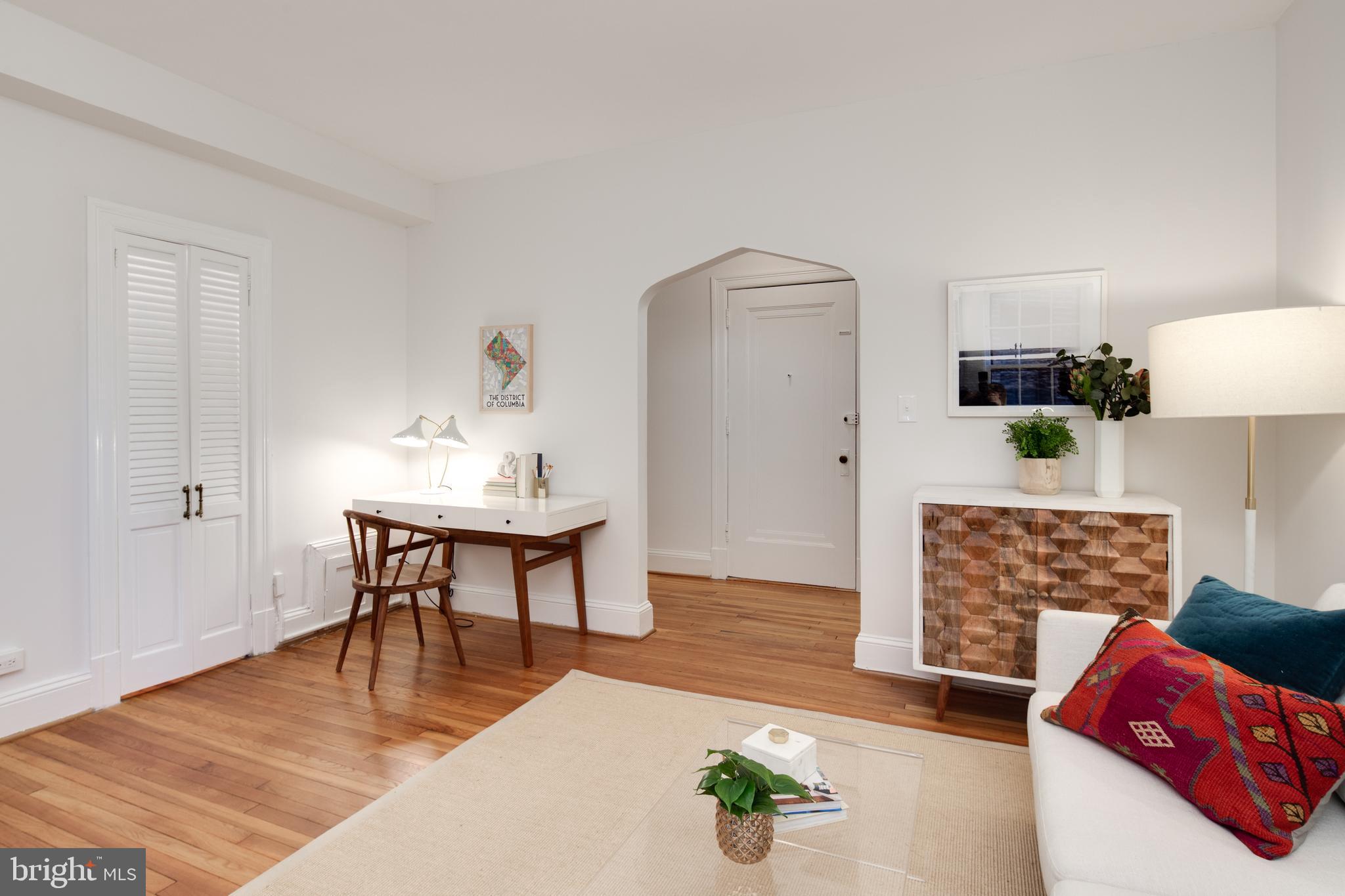 2707 Adams Mill Road Northwest, Unit 303 Washington, DC 20009 - Photo 9 of 30 a view of a livingroom with furniture and wooden floor