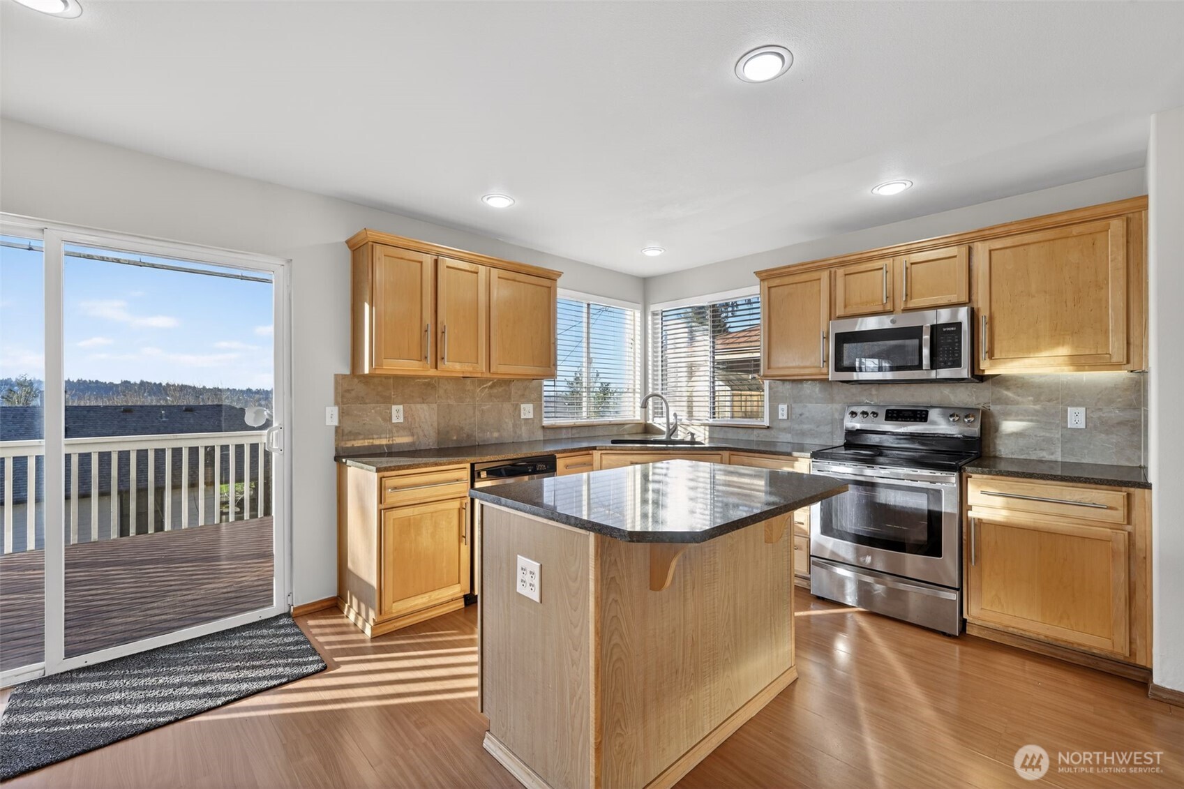 2103 Northeast 6th Circle Renton, WA 98056 - Photo 12 of 38 a kitchen with a stove a sink and a microwave