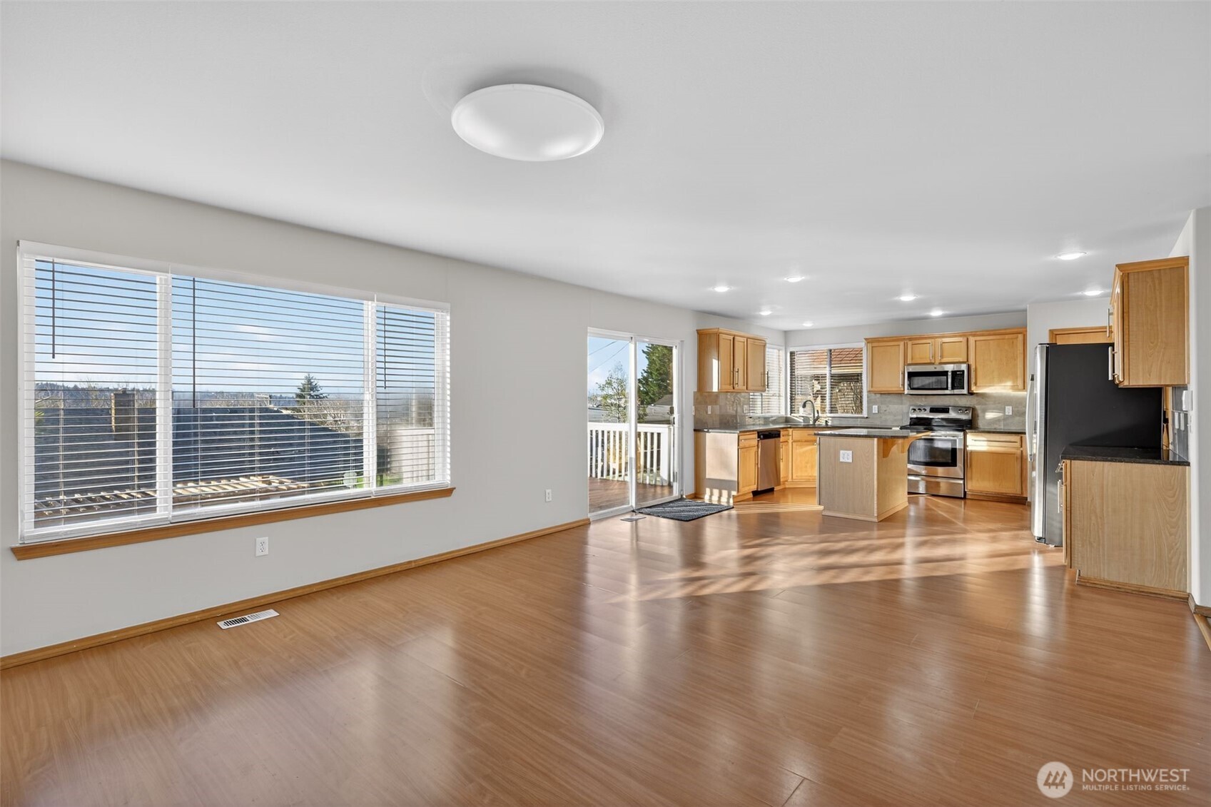 2103 Northeast 6th Circle Renton, WA 98056 - Photo 14 of 38 a view of an empty room with wooden floor and a window