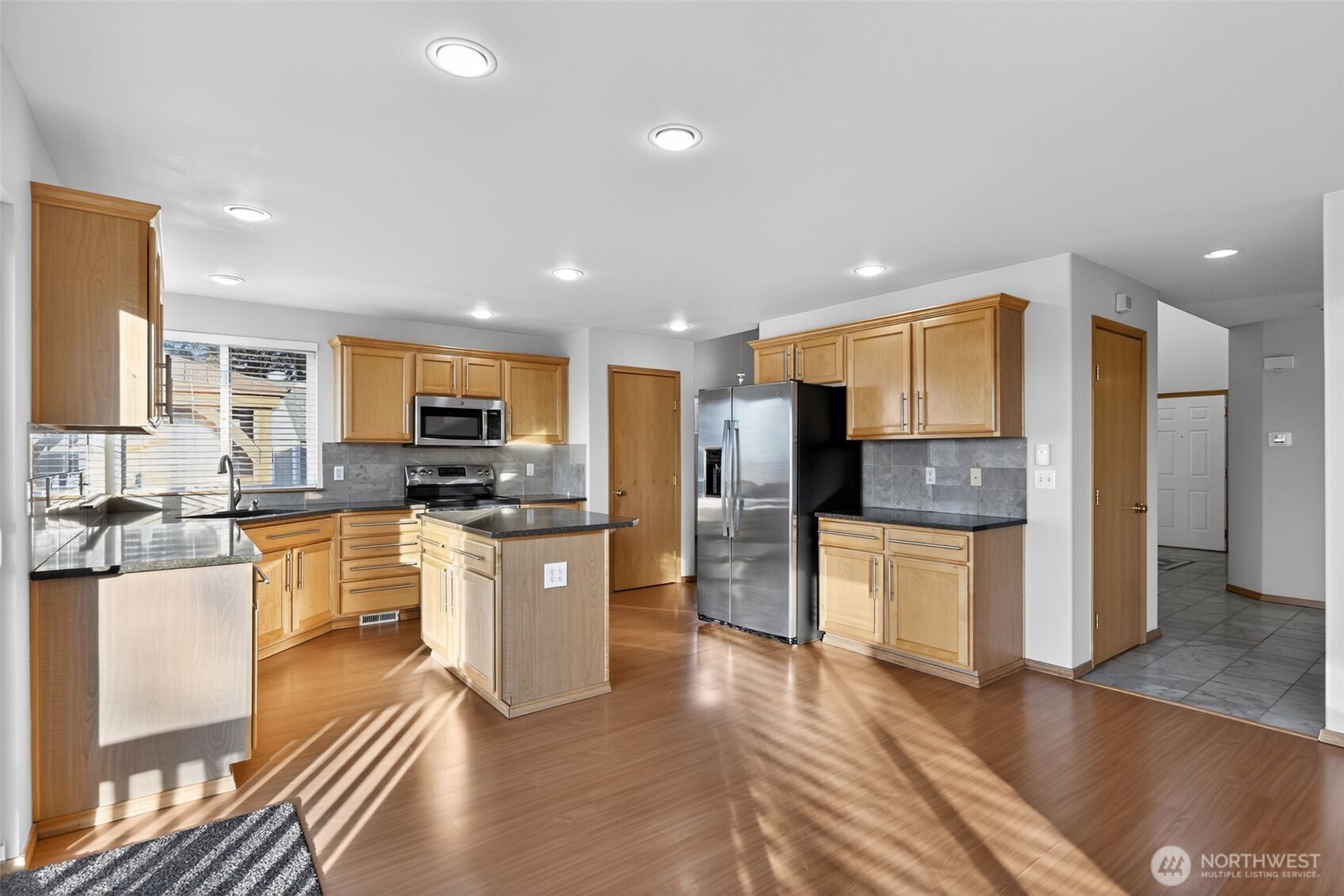 2103 Northeast 6th Circle Renton, WA 98056 - Photo 15 of 38 a large kitchen with cabinets and wooden floor