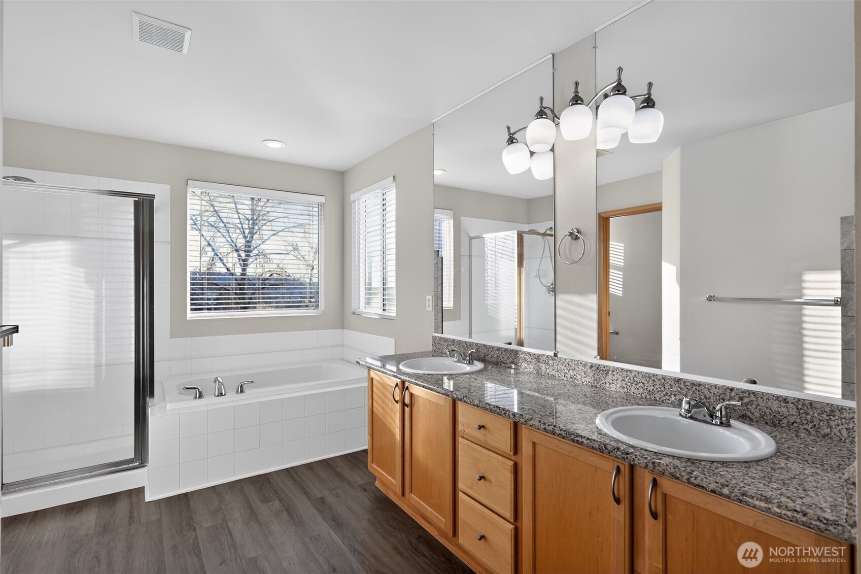2103 Northeast 6th Circle Renton, WA 98056 - Photo 19 of 38 a spacious bathroom with a granite countertop sink mirror and a bathtub