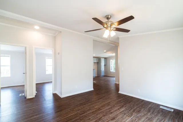 a view of an empty room with wooden floor